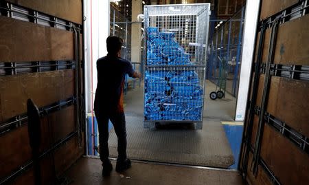 An employee prepares merchandise sold via eCommerce to be delivered to customers at retail chain Magazine Luiza S.A logistics center in Louveira, Brazil April 24, 2018. REUTERS/Paulo Whitaker