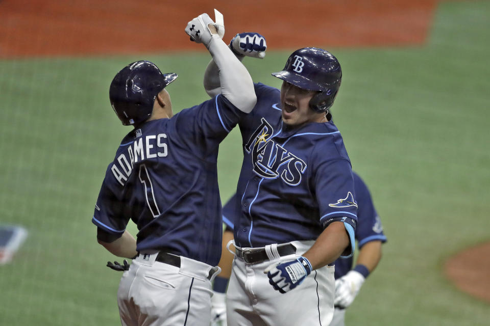 Tampa Bay Rays' Hunter Renfroe, right, celebrates with Willy Adames after Renfroe hit a three-run home run off Atlanta Braves relief pitcher Touki Toussaint during the fourth inning of a baseball game Monday, July 27, 2020, in St. Petersburg, Fla. (AP Photo/Chris O'Meara)