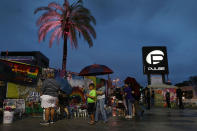 <p>People visit the memorial to the victims of the mass shooting setup around the Pulse gay nightclub one day before the one year anniversary of the shooting on June 11, 2017 in Orlando, Florida. (Joe Raedle/Getty Images) </p>