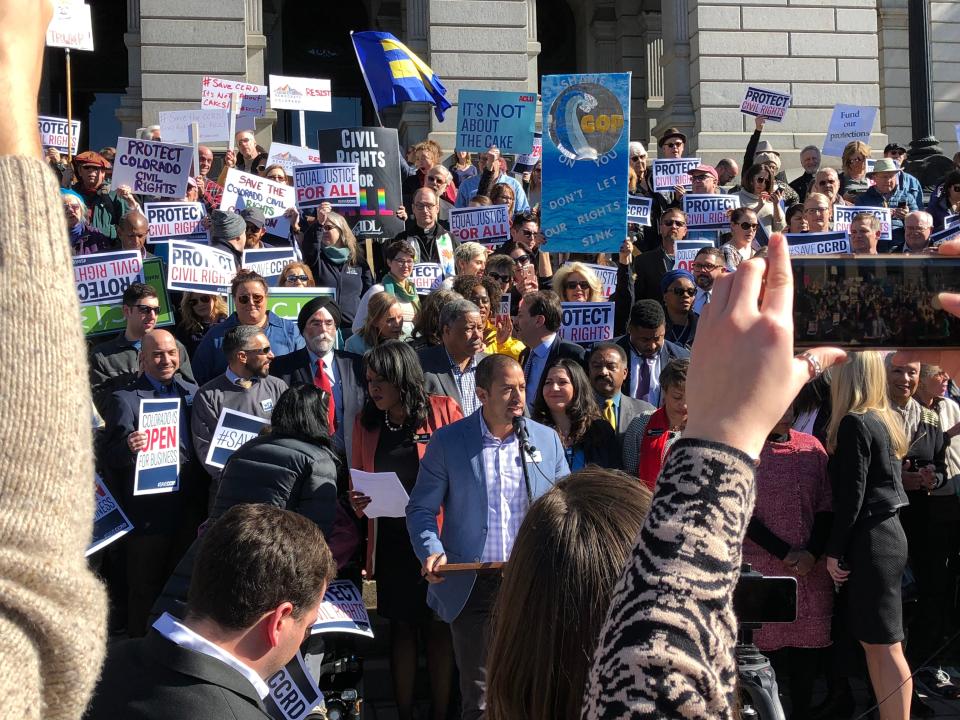 Daniel Ramos of One Colorado, center, speaks at a rally to save the Colorado Civil Rights Division, which was under threat to be de-funded in 2018.