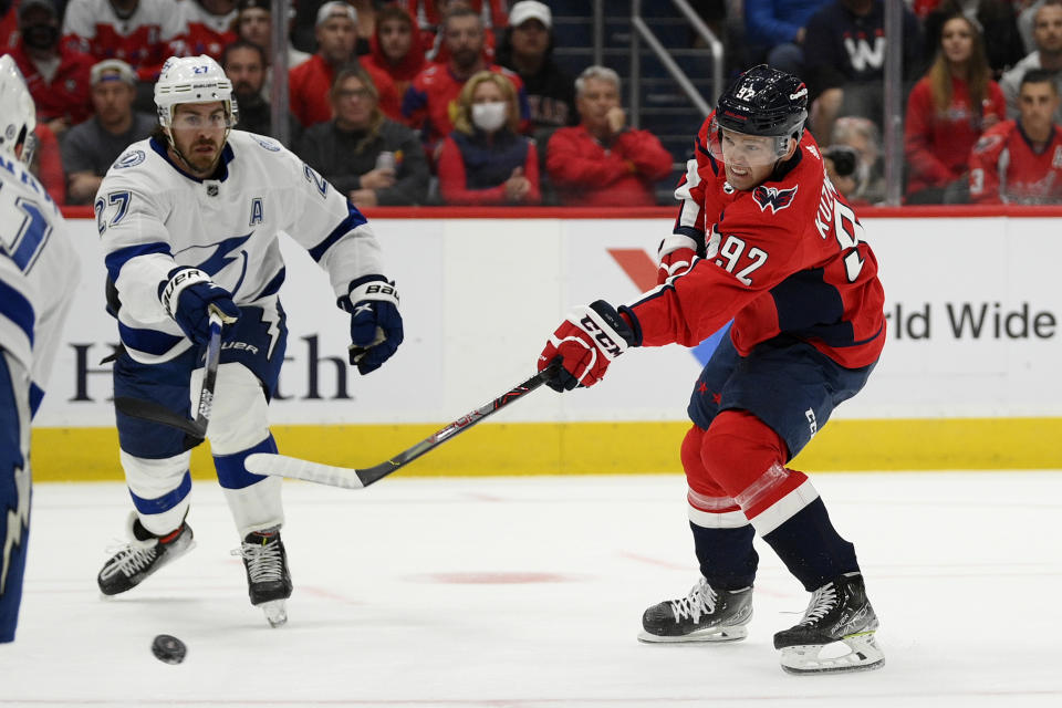 Washington Capitals center Evgeny Kuznetsov (92) shoots the puck against Tampa Bay Lightning defenseman Ryan McDonagh (27) during the first period of an NHL hockey game, Saturday, Oct. 16, 2021, in Washington. (AP Photo/Nick Wass)