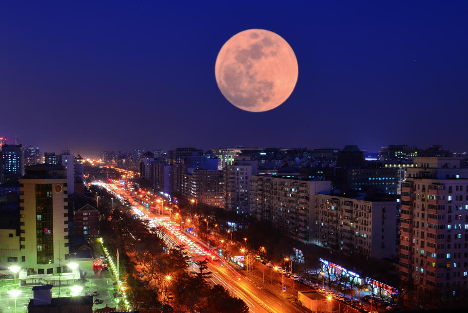 BEIJING, CHINA - JANUARY 31:  (Image taken with double exposure) A Super Blood Moon rises over buildings on January 31, 2018 in Beijing, China. The moon turns red and blue during a total lunar eclipse on Wednesday night.  (Photo by Visual China Group via Getty Images/Visual China Group via Getty Images)