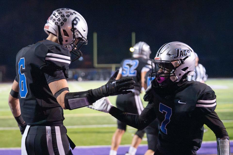 Hilliard Bradley's Preston Wolfe (6) celebrates with Daniel Shaffer (7) after scoring a touchdown Friday night.