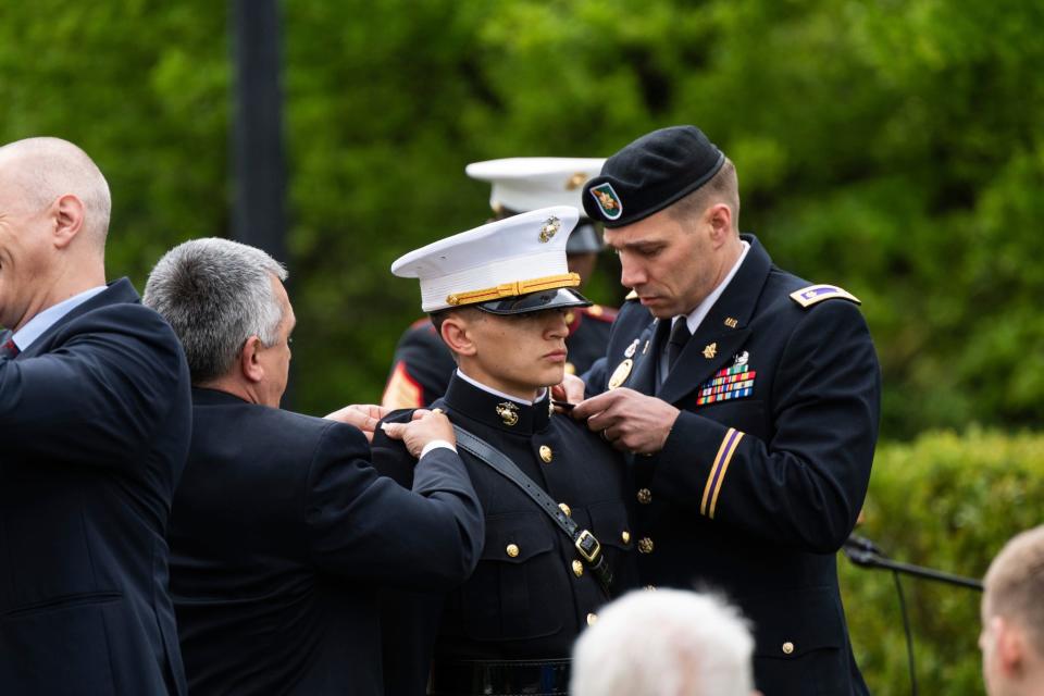 Marine Corps 2nd Lt. Joseph Randolph's rank is pinned on his dress blue uniform during a commissioning ceremony Saturday at Hillsdale College.