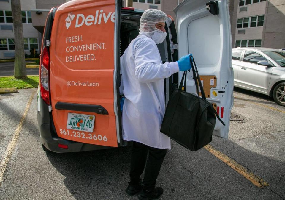 On Jan. 7, 2021, Yuri Kuzenkov of DeliverLean takes out a bag containing pre-packaged meals being delivered to a client in Miami-Dade’s senior meals program, launched in the spring of 2020 to encourage the most vulnerable residents to isolate at home.