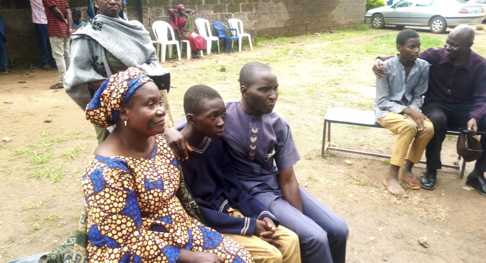 Parents are reunited with released students of the Bethel Baptist High School in Damishi, Nigeria, on Sunday, July 25, 2021. Armed kidnappers in Nigeria have released 28 of the more than 120 students who were abducted at the beginning of July from the Bethel Baptist High School in the northern town of Damishi. Church officials handed those children over to their parents at the school on Sunday. (AP Photo)