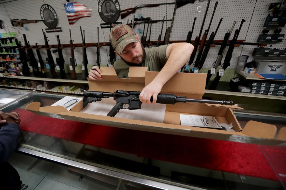 Fletcher Arms employee Ryan Dieter packs up an Anderson Manufacturing AM-15 rifle on  Jan. 19.