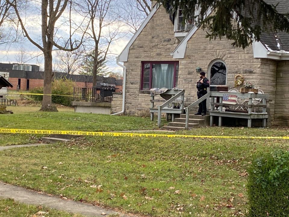 A Muncie police officer stands outside a home, in the 1500 block of South Burlington Drive, where a child was shot early Monday afternoon.