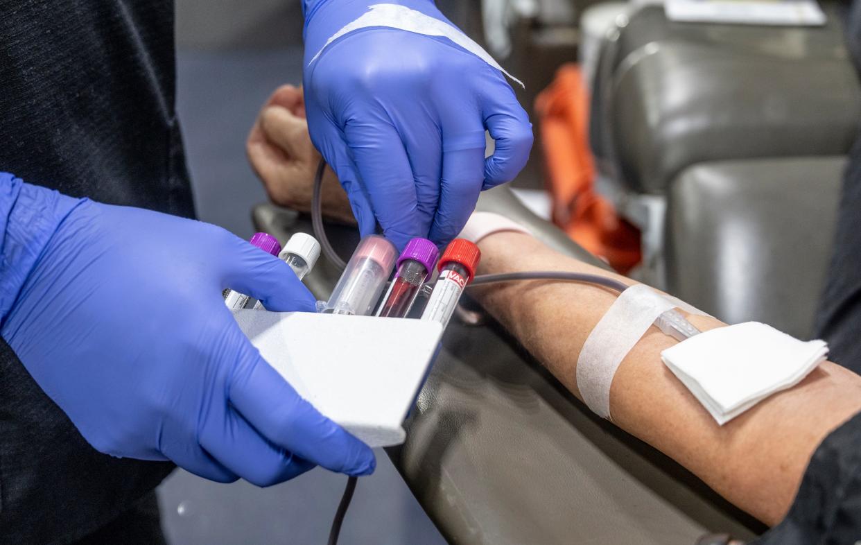 A nurse fills test tubes with blood to be tested during a bloodmobile in Fullerton, CA on Thursday, January 20, 2022.