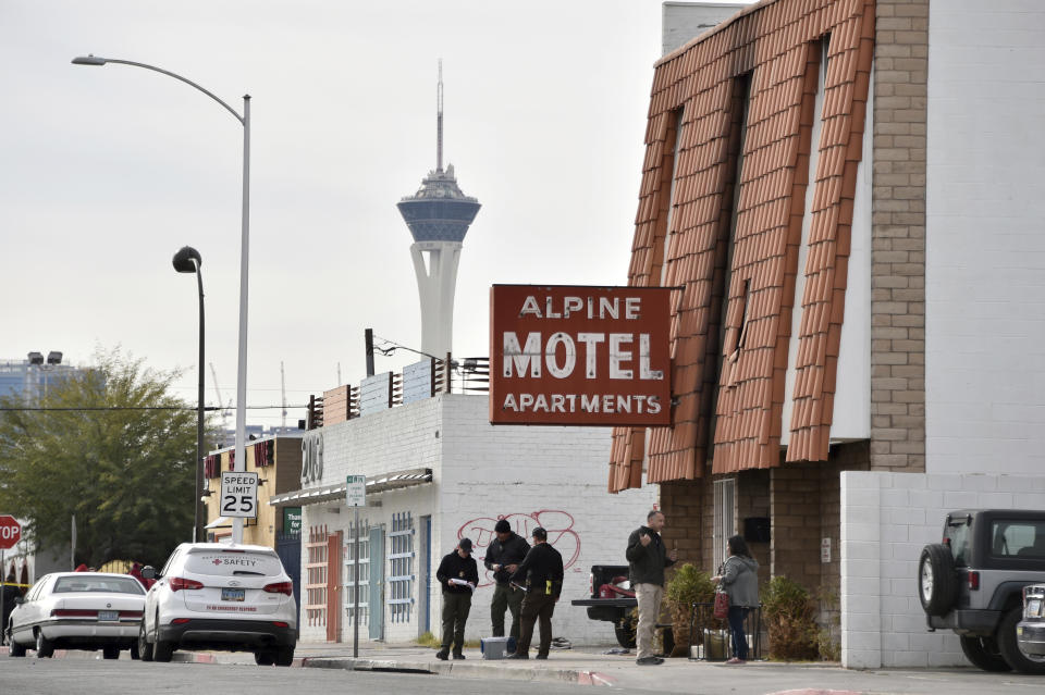 Investigators work at the scene of a three-story apartment complex fire early Saturday, Dec. 21, 2019 in Las Vegas. The fire was in first-floor unit of the Alpine Motel Apartments and its cause was under investigation, the department said. Authorities say multiple fatalities were reported and many more were injured. (AP Photo/David Becker)