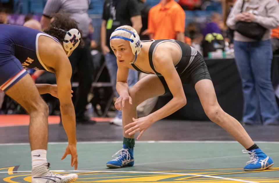 Washburn Rural's Cooper Stivers wrestles against Manhattan's Jameal Agnew in the 6A semifinals for  the 132 weight class at Hartman Arena on Friday, Feb. 24, 2023.