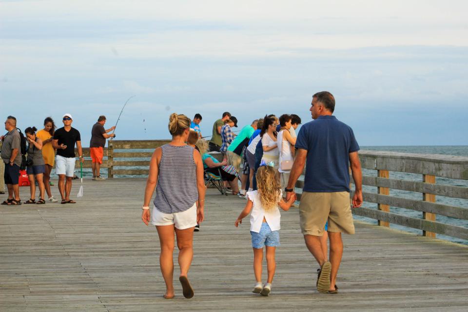 People walk along Crystal Pier at Wrightsville Beach, N.C. Saturday August 31, 2019, over Labor Day weekend to enjoy the last official beach weekend of the season. Try sitting a spell on one of our local piers for a different perspective.