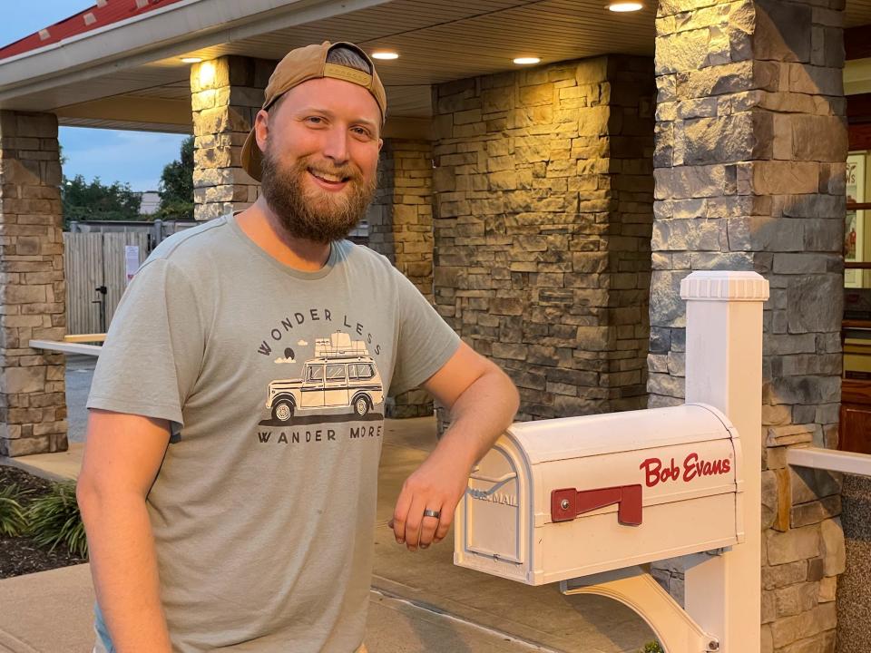 tim posing in front of bob evans mail box