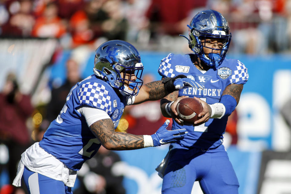 Kentucky quarterback Lynn Bowden Jr. hands off to running back Christopher Rodriguez Jr. who rushes for a touchdown against Virginia Tech in the first half of the Belk Bowl NCAA college football game in Charlotte, N.C., Tuesday, Dec. 31, 2019. (AP Photo/Nell Redmond)