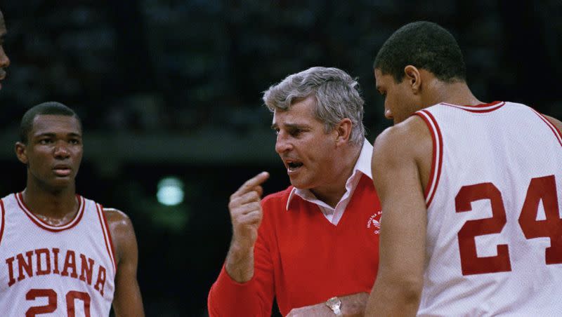 Indiana coach Bob Knight gestures while instructing players, including Rick Calloway (20) and Daryl Thomas (24), during a win over UNLV in an NCAA men’s college basketball tournament semifinal March 30, 1987, in New Orleans. Knight, the brilliant and combustible coach who won three NCAA titles at Indiana and for years was the scowling face of college basketball, has died. He was 83. Knight’s family made the announcement on social media on Wednesday night, Nov. 1, 2023, saying he was surrounded by family members at his home in Bloomington, Ind. 