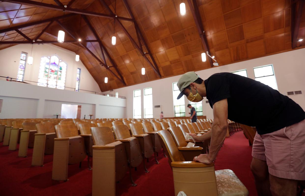 Alamo Heights Baptist Church pastor Bobby Contreras, right, works to clean, sanitize and prepare his church for services this Sunday in San Antonio on Wednesday, May 6, 2020. Texas' stay-at-home orders due to the COVID-19 pandemic have expired and Texas Gov. Greg Abbott has eased restrictions on many businesses that have now opened, churches and places or worship may resume live services with 25% capacity.