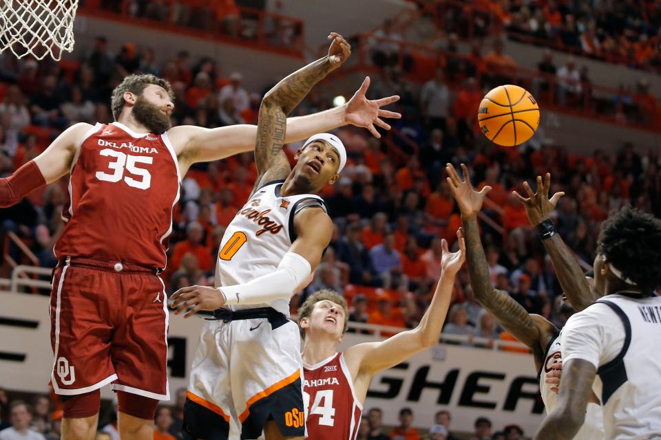 Oklahoma State Cowboys guard Avery Anderson III (0) goes for the ball beside Oklahoma Sooners forward Tanner Groves (35) during a men's Bedlam college basketball game between the Oklahoma State University Cowboys (OSU) and the University of Oklahoma Sooners (OU) at Gallagher-Iba Arena in Stillwater, Okla., Wednesday, Jan. 18, 2023. Oklahoma State won 72-56.