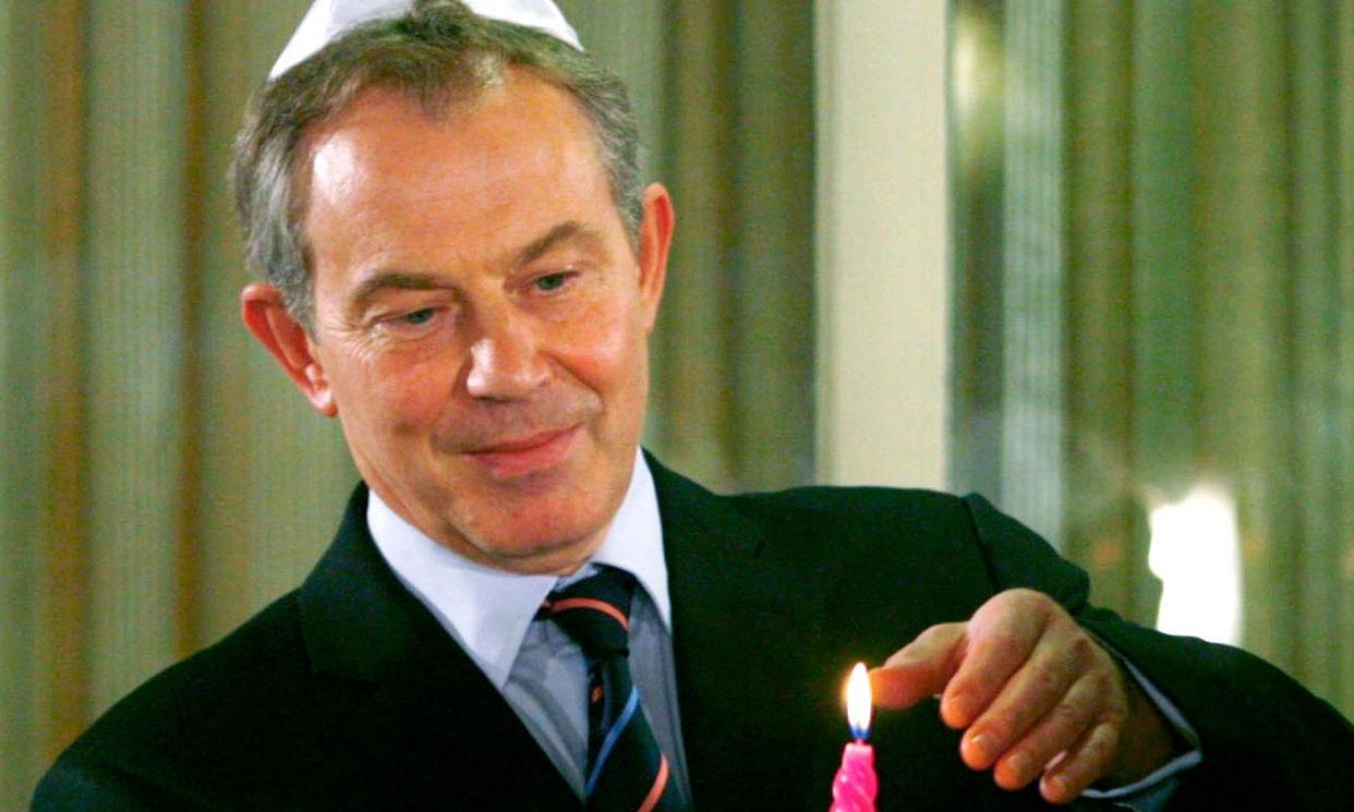 <span>Tony Blair lights a candle for Hanukkah in 2006.</span><span>Photograph: Ronen Zvulun/Reuters</span>