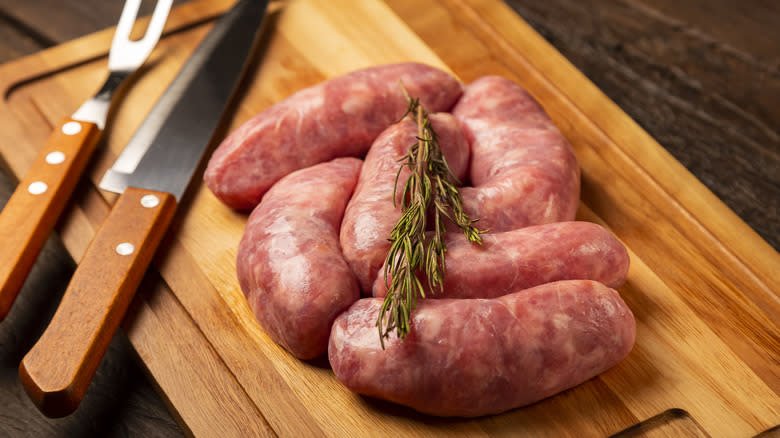 Raw linguica sausage on cutting board