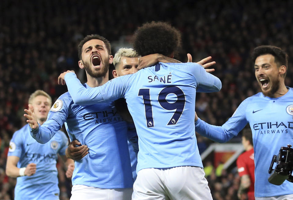 Manchester City's Leroy Sane, 2nd right, celebrates after scoring his side's second goal during the English Premier League soccer match between Manchester United and Manchester City at Old Trafford Stadium in Manchester, England, Wednesday April 24, 2019. (AP Photo/Jon Super)