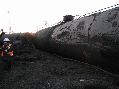 An investigator works at the scene of a January 7 derailment involving a Canadian National Railway (CN) mixed freight train near Plaster Rock, New Brunswick in this image obtained from The Transportation Safety Board of Canada on January 10, 2014. REUTERS/The Transportation Safety Board of Canada/Handout via Reuters