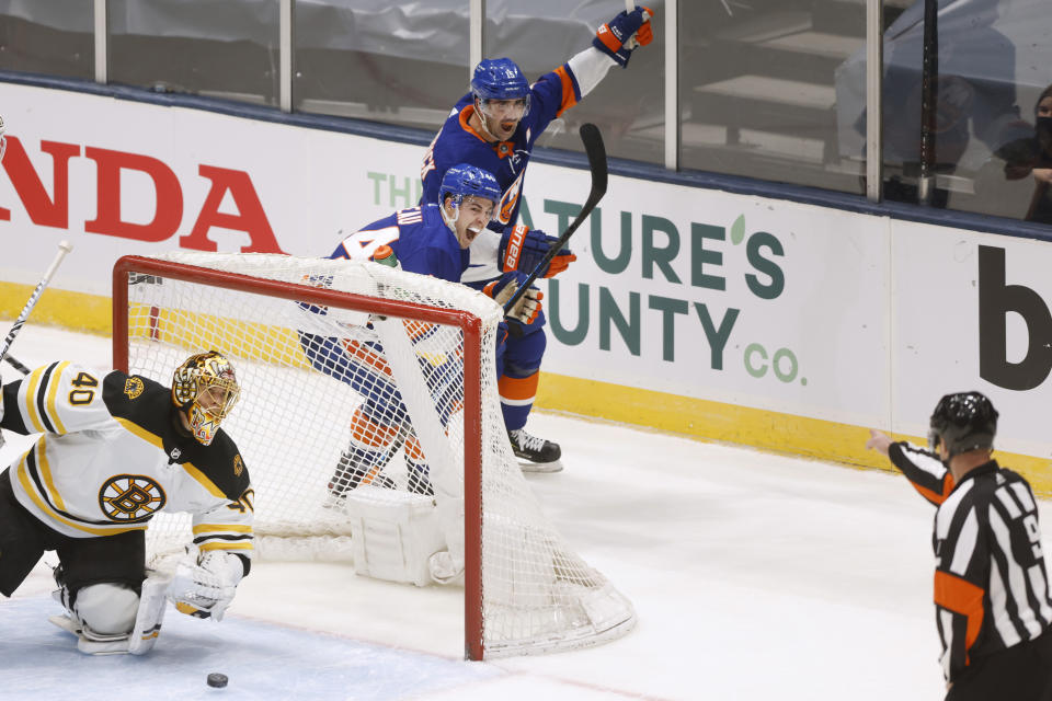 New York Islanders' Jean-Gabriel Pageau (44) celebrates with teammate Cal Clutterbuck (15) after scoring against Boston Bruins goalie Tuukka Rask (40), of Finland, during the third period of an NHL hockey game Monday, Jan. 18, 2021, in Uniondale, N.Y. (AP Photo/Jason DeCrow)