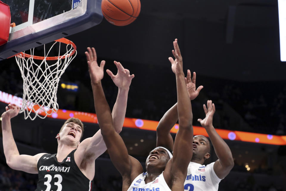 Memphis' forward Malcomb Dandridge ( 23) and Cincinnati's center Chris Vogt (33) go up for a rebound in the first half of an NCAA college basketball game Thursday, Jan. 16, 2020, in Memphis, Tenn. (AP Photo/Karen Pulfer Focht)