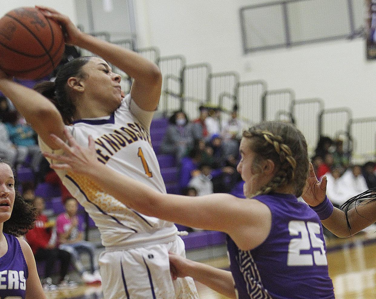 Reynoldsburg's Mya Perry and Pickerington Central's Taylor Kelley fight for a rebound during the host Raiders' 56-53 victory Jan. 13. The Raiders are awaiting the return of senior point guard Makiya Miller, who had surgery Dec. 16 because of a broken bone in her left foot.