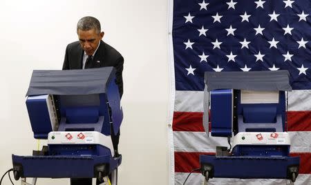 U.S. President Barack Obama takes part in early voting at a polling station in Chicago, Illinois October 20, 2014. REUTERS/Kevin Lamarque