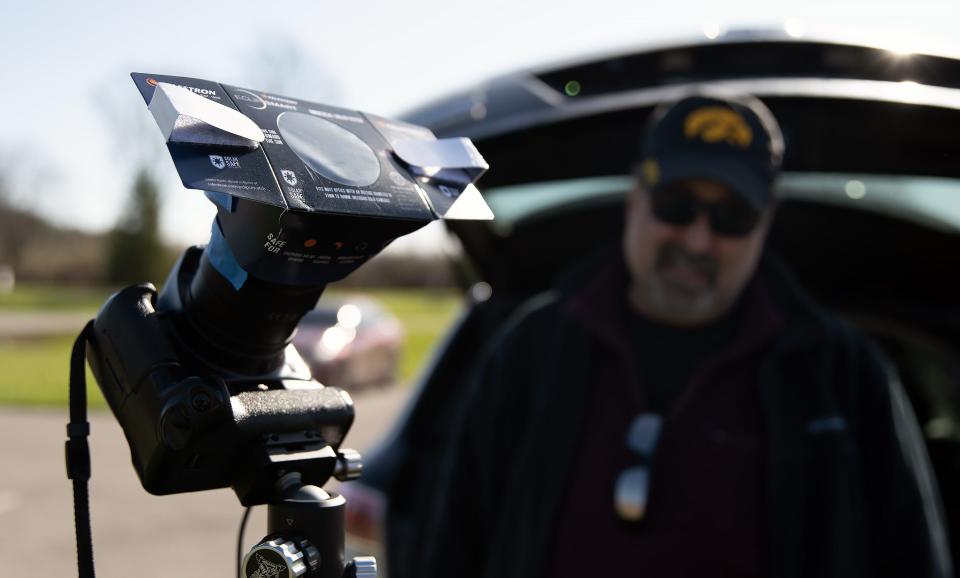 Dan Masini, of Grand Rapids, Michigan, sets up his camera to capture a time-lapse of MondayÕs total solar eclipse in the parking lot of the Indian Lake State Park campgrounds. Masini drove three and a half hours Sunday with his dog, Nellie, to witness the eclipse. He mapped out every time he needs to adjust his cameraÕs settings and when he can take off its filter during totality.