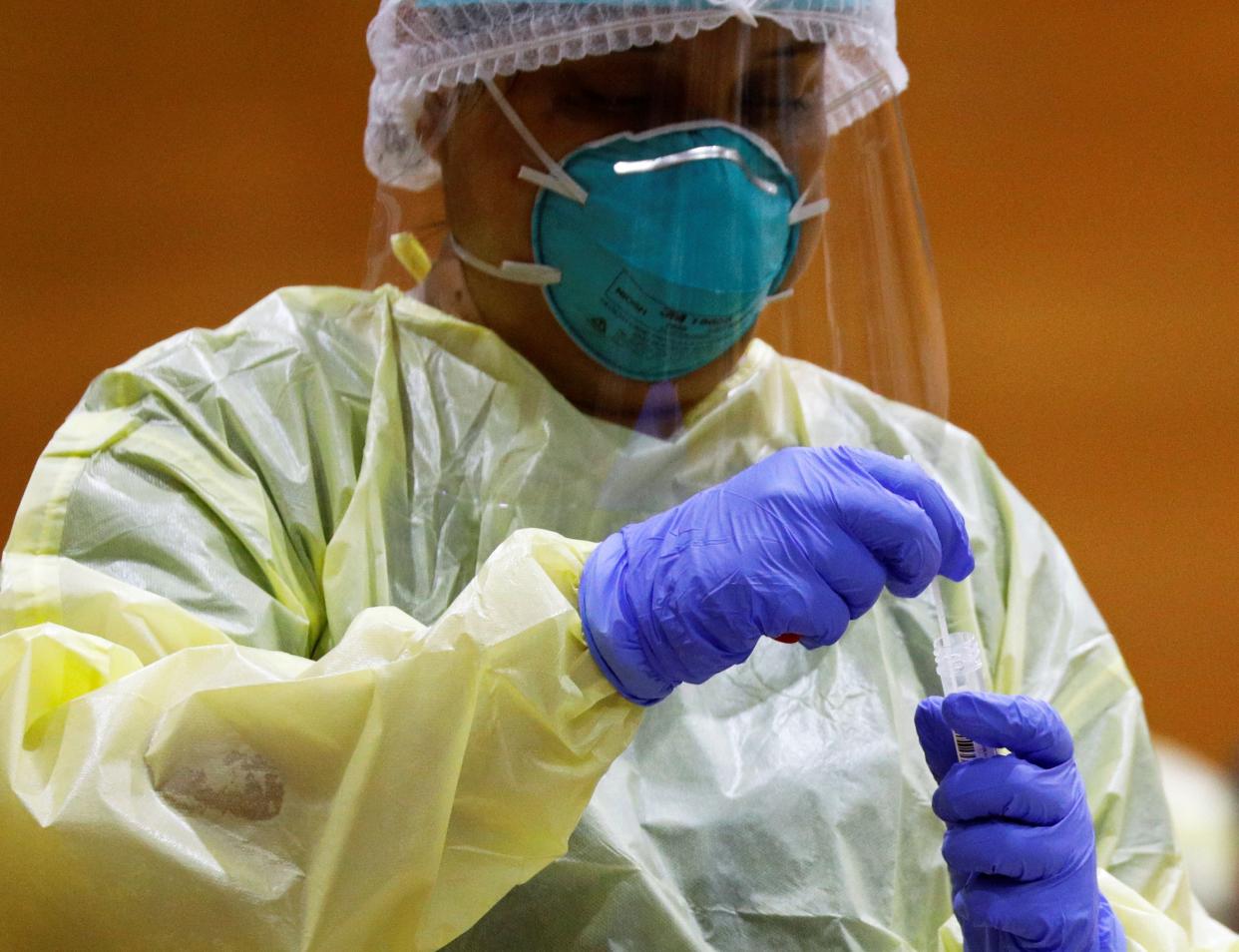 A medical worker collects a nasal swab sample at a regional screening center, amid the coronavirus disease (COVID-19) outbreak in Singapore June 10, 2020.   REUTERS/Edgar Su