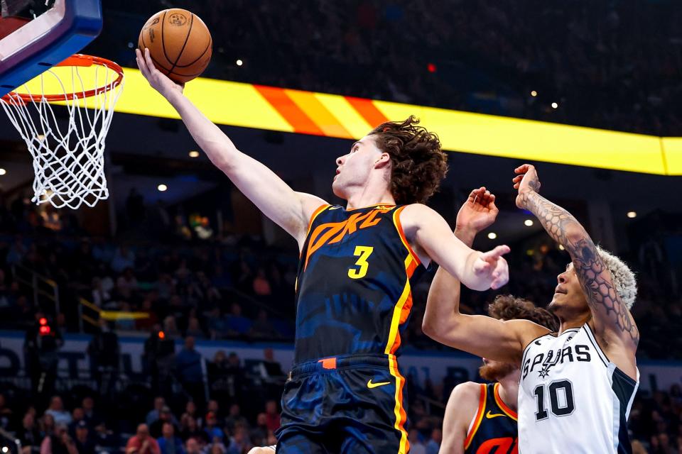Oklahoma City guard Josh Giddey (3) jumps for a layup past San Antonio forward Jeremy Sochan (10) in the second quarter during an NBA game between the Oklahoma City Thunder and the San Antonio Spurs at the Paycom Center in Oklahoma City, on Tuesday, Nov. 14, 2023.