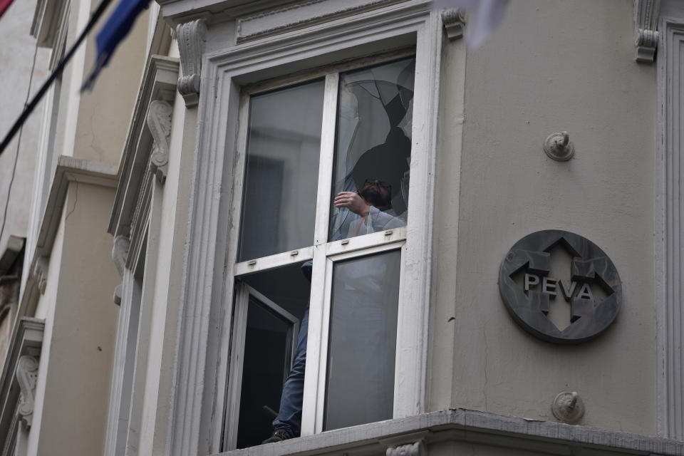 A man removes broken glass caused by Sunday's explosion on Istanbul's popular pedestrian Istiklal Avenue in Istanbul, Monday, Nov. 14, 2022. Turkey's interior minister says police have detained a suspect who is believed to have planted the bomb that exploded on a bustling pedestrian avenue in Istanbul. He said Monday that initial findings indicate that Kurdish militants were responsible for the attack. (AP Photo/Khalil Hamra)