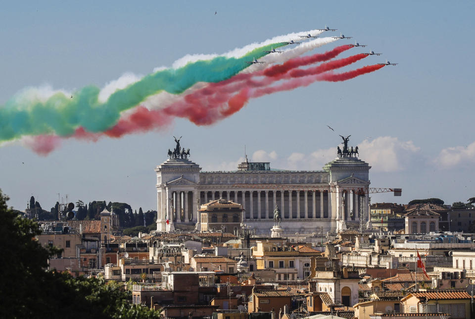 The Frecce Tricolori (Tricolor Arrows) aerobatic squad of the Italian Air Force fly over Rome and the Unknown Soldier monument, visible in foreground, Tuesday, June 2, 2020, as part of the celebrations for the 74th anniversary of the Italian Republic born on June 2, 1946. (AP Photo/Alessandra Tarantino)