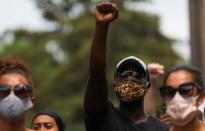 A man gestures as he stands outside during a memorial service for George Floyd following his death in Minneapolis police custody, in Minneapolis