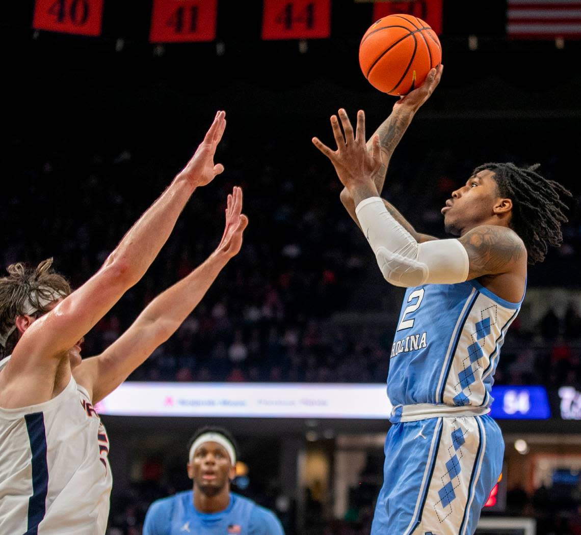 North Carolina’s Caleb Love (2) drives to the basket against Virginia’s Ben Vander Plas (5) in the second half on Tuesday, January 10, 2023 at John Paul Jones Arena in Charlottesville, Va. Love scored 13 points.