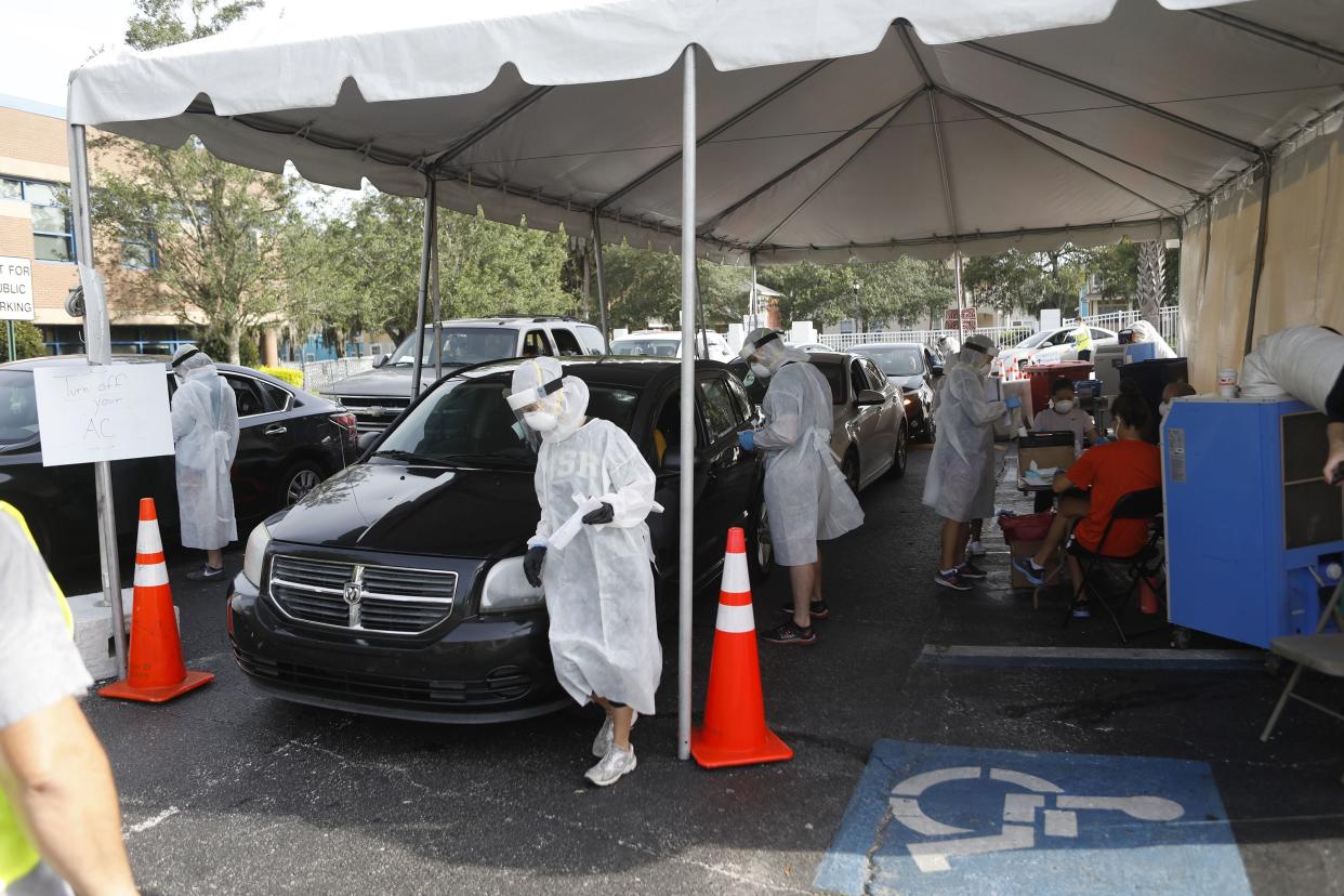 Healthcare workers from University of South Florida (USF) Health administer coronavirus testing at the Lee Davis Community Resource Center on June 25, 2020 in Tampa, Florida.