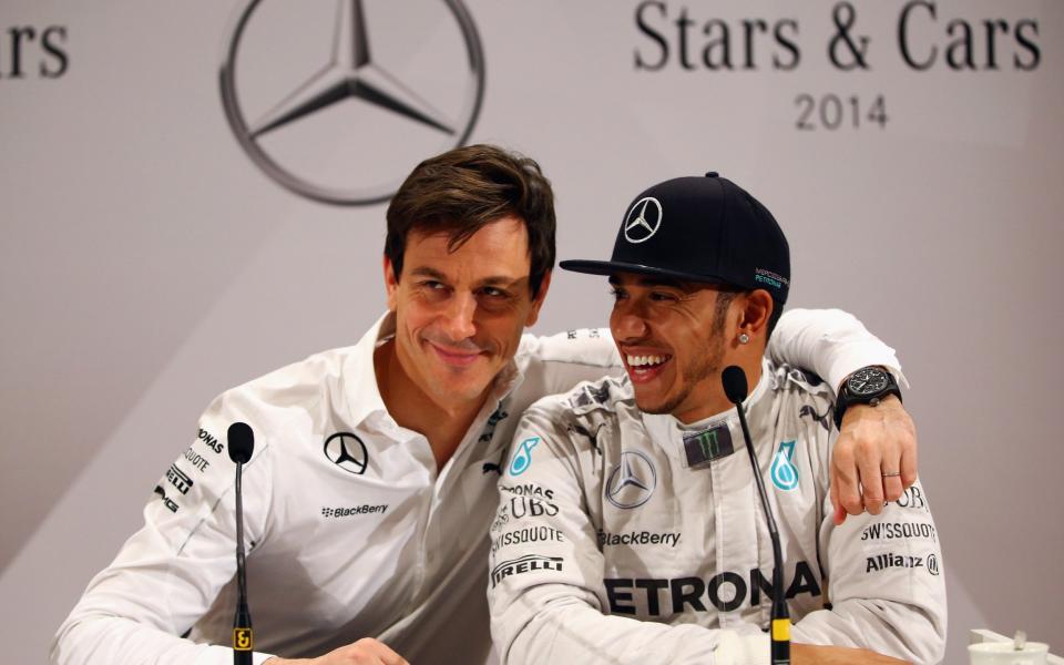 Mercedes GP CEO Toto Wolff hugs Lewis Hamilton of Great Britain during a press conference at the annual Mercedes Benz Stars & Cars event in front of the Mercedes Benz Museum on November 29, 2014 in Stuttgart, Germany