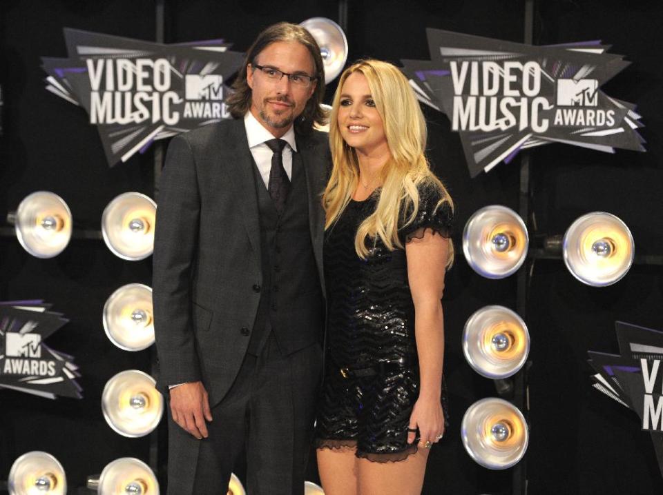 FILE - In this Aug. 28, 2011 file photo, Jason Trawick and Britney Spears arrive at the MTV Video Music Awards in Los Angeles. A judge says Spears' one-time fiance Jason Trawick has resigned as her co-conservator on Friday Jan. 11, 2013. (AP Photo/Chris Pizzello, file)