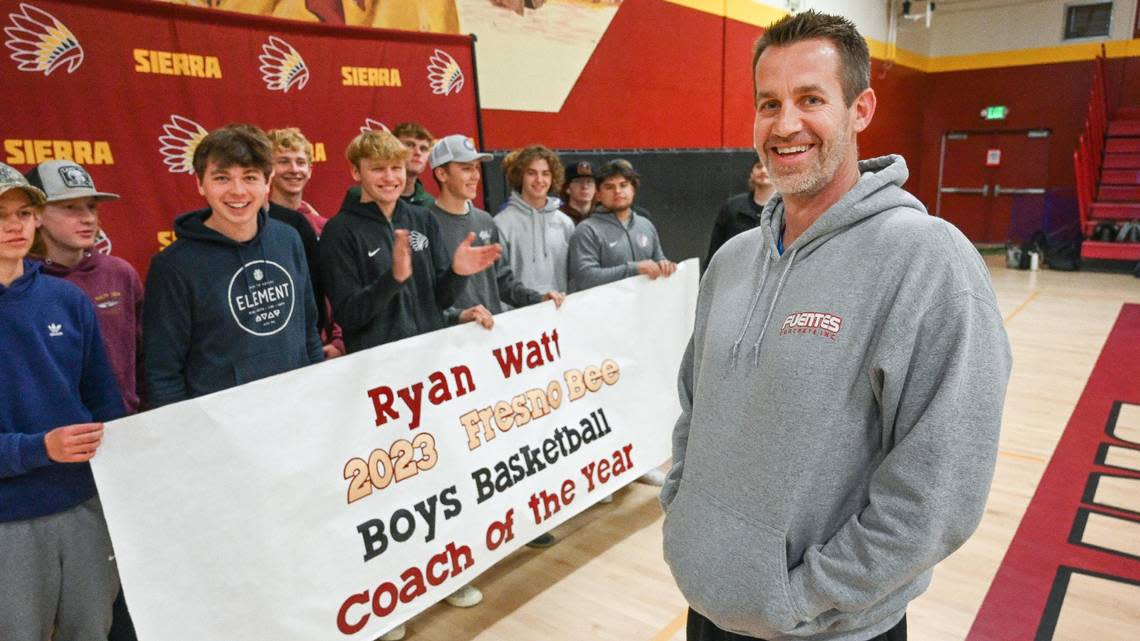 Sierra High School boys basketball coach Ryan Watt is surprised by his players with a banner after being named The Fresno Bee’s boys high school basketball Coach of the Year.