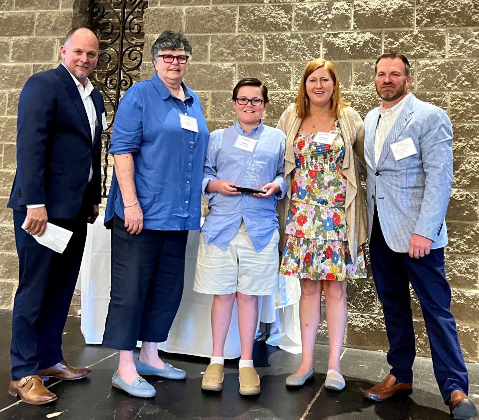 The Karyn Holbrook Spirit of Service Award is presented to her family including Karyn’s widow, Diana Harrell, daughter Heather Holbrook and grandson Keaton Holbrook. With them are CEO Steve Jenkins and board president Tate Coffey.