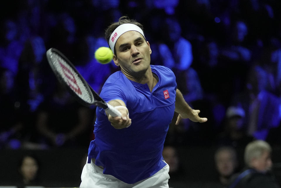 Team Europe's Roger Federer returns the ball as he and Rafael Nadal play in a Laver Cup doubles match against Team World's Jack Sock and Frances Tiafoe at the O2 arena in London, Friday, Sept. 23, 2022. (AP Photo/Kin Cheung)