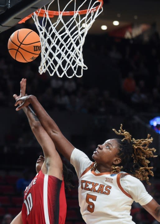 Texas forward DeYona Gaston (5) blocks a shot by North Carolina State guard Aziaha James (10) during the first half of an Elite Eight college basketball game in the women’s NCAA Tournament, Sunday, March 31, 2024, in Portland, Ore. (AP Photo/Steve Dykes)