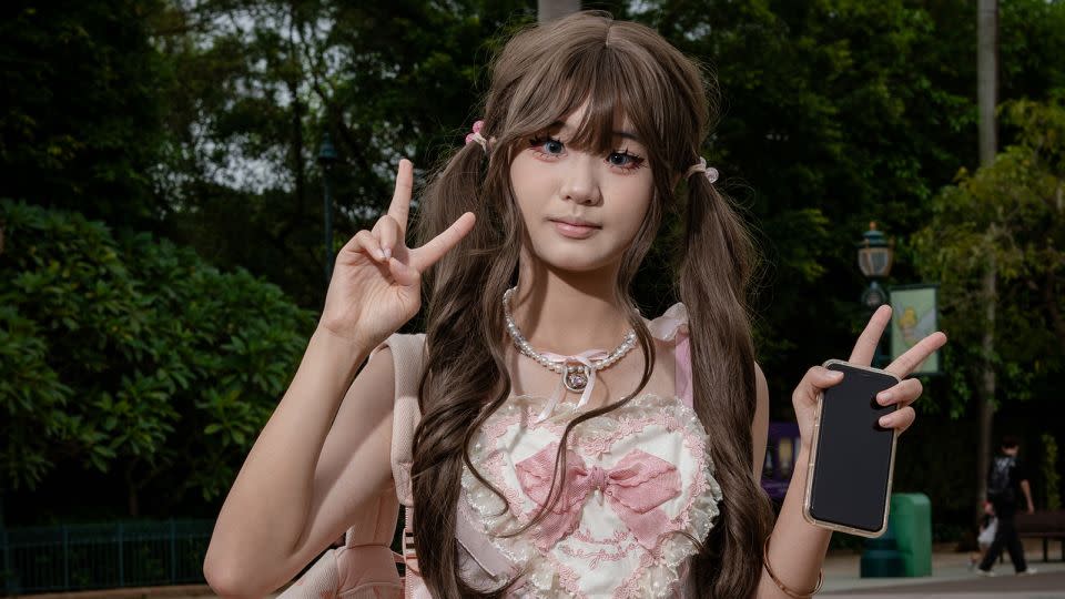 Hair carefully coiffed, and in full makeup Liang Xiaoyu, 18, is dressed for a day out at Hong Kong Disneyland. She was on her way to meet a friend. - Noemi Cassanelli/CNN