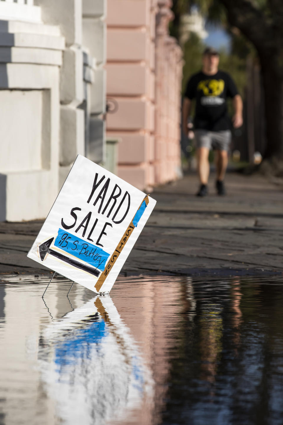 A yard sale sign reflects in flood waters as a king tide rolls into the Battery in Charleston, S.C. Sunday, Nov. 15, 2020. Charleston has remained relatively unscathed this hurricane season. That means more time to mull a $1.75 billion proposal by the Army Corps of Engineers that features a sea wall along the city's peninsula to protect it from deadly storm surge during hurricanes. (AP Photo/Mic Smith)