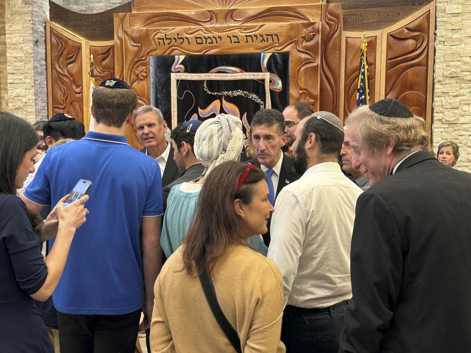 Tennessee Gov. Bill Lee, third left, and Rep. David Kustoff, R-Tenn., fourth right, speak with people at Margolin Hebrew Academy-Feinstone Yeshiva of the South on Monday, Oct. 30, 2023, in Memphis, Tenn. Lee and Kustoff are praising security measures at the school where an ex-student with a gun was stopped from entering the building in July. (AP Photo/Adrian Sainz).