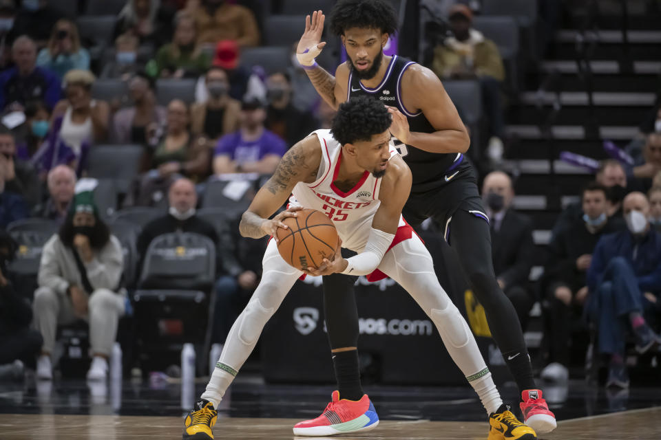 Houston Rockets center Christian Wood (35) is guarded by Sacramento Kings forward Marvin Bagley III during the second half of an NBA basketball game in Sacramento, Calif., Friday, Jan. 14, 2022. The Kings won 126-114. (AP Photo/Randall Benton)