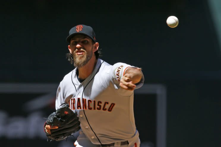 San Francisco Giants' Madison Bumgarner throws a pitch against the Arizona Diamondbacks during the first inning of an Opening Day baseball game Sunday, April 2, 2017, in Phoenix. (AP Photo/Ross D. Franklin)