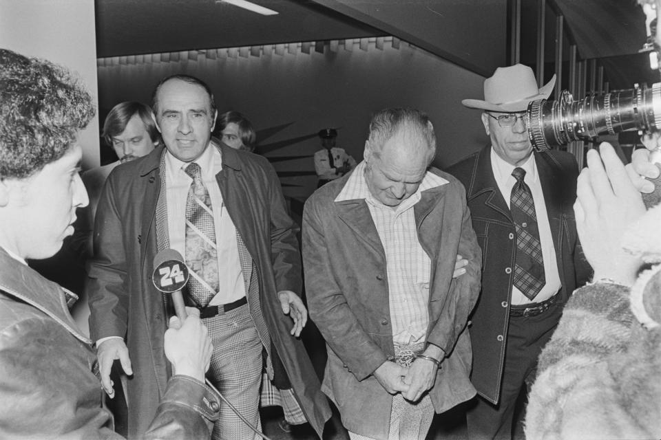 The secret flight of Sheriff Raymond Frank, left, to Oklahoma City, where he convinced accused robber Red Holt, right, to return with him to Austin, met with disapproval from D.A. Ronnie Earle, a federal grand jury and the FBI. The reporter on the left is Victor Solis; Chief Deputy Jim Collier (in hat) stands at the far right.