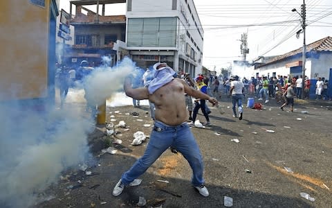 Venezuelans hold a protest in the border city of Urena - Credit: AFP